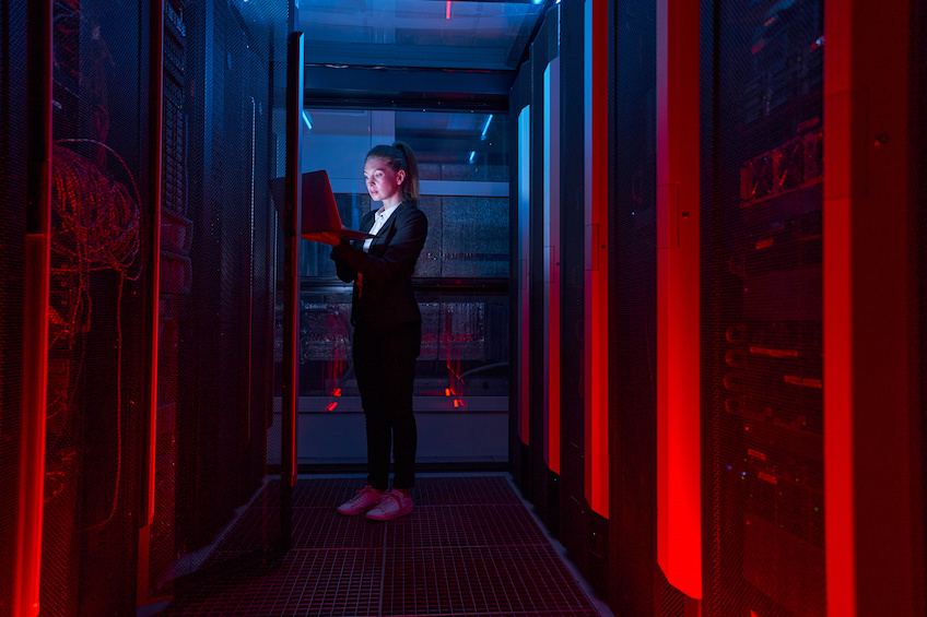 Woman working on servers in data center